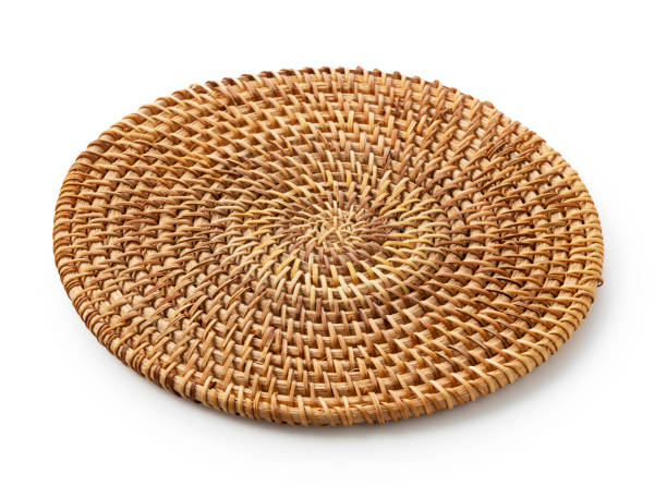 istock Handmade round woven placemat placed on a white background. 1353355875