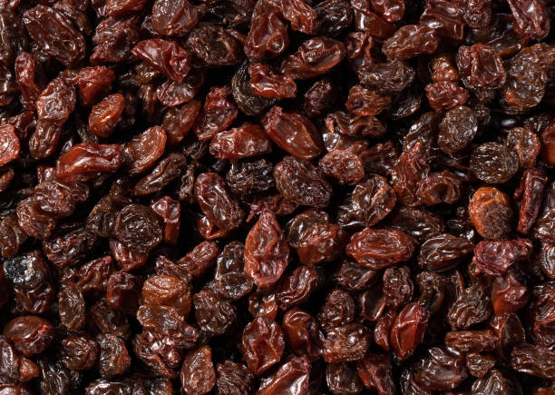 istock Grape raisin texture in the background. View from directly above. 1353355929