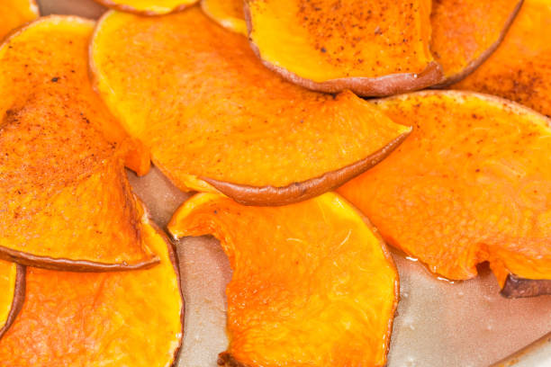 istock Homemade pumpkin sweet chips on the baking sheet close-up 1353357178