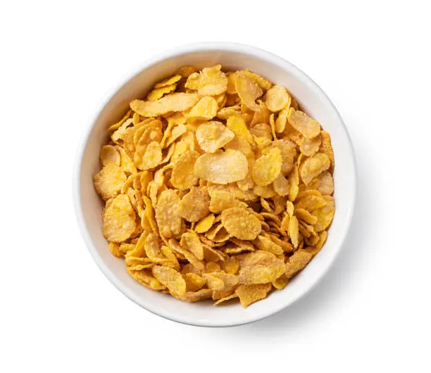 Cornflakes in a white ceramic bowl. View from directly above."n
