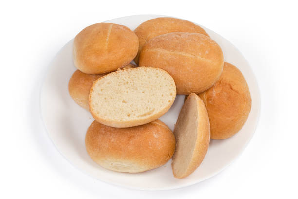 istock Pile of small buns, one bun cut horizontally on dish 1353357266