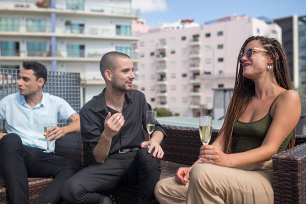 istock Optimistic colleagues on terrace roof party 1353357316
