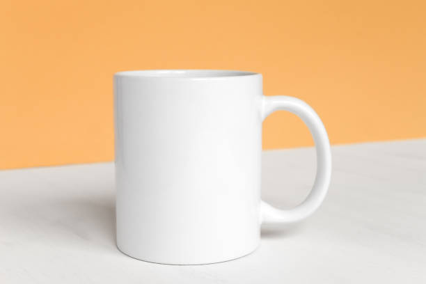 istock One white cup on the table close-up front view. Layout
for design with copy space. Template and preparation for advertising and presentation. 1353358760