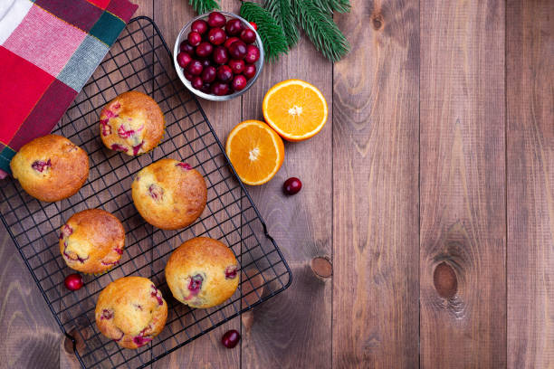 istock Cranberry orange muffins on cooling rack, horizontal, top view, copy space, Christmas decoration 1353358858