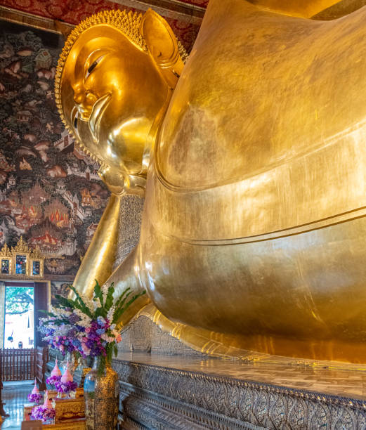 istock Giant reclining Buddha in Thai temple 1353359003
