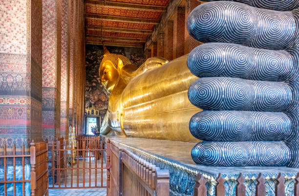 istock Giant reclining Buddha in Thai temple 1353359040