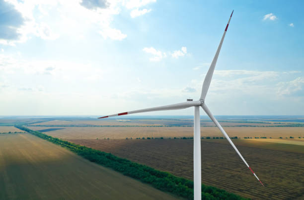 istock Modern windmill in wide field. Energy efficiency 1353361976