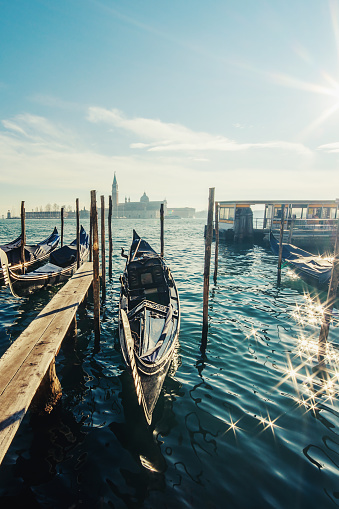 Docked gondolas in San Zaccaria and glimpse of San Giorgio Maggiore island - Venice