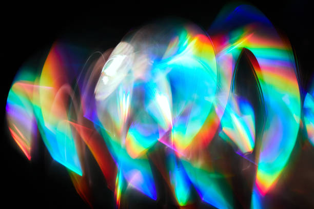 istock Blurred Light painting one exposure in camera. light glares with a spectral gradient on a dark background. Multicolored abstract colorful line. Unusual light effect. 1353364659