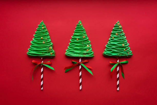 istock Three meringue trees in New Year's style on a red background. 1353364802