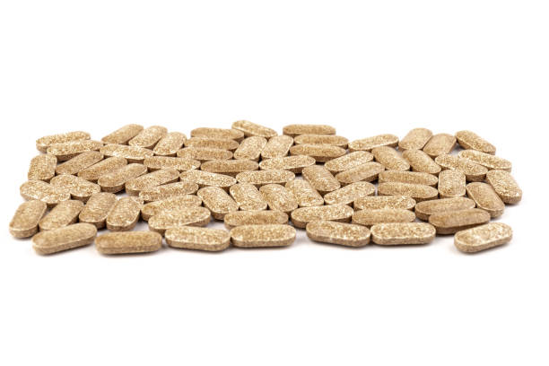 istock Nutrition supplements, brown vitamin pills on white background. 1353365127