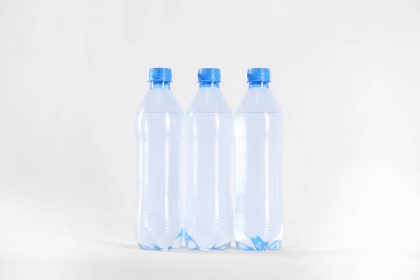 istock Plastic bottles with pure water on white background 1353365514