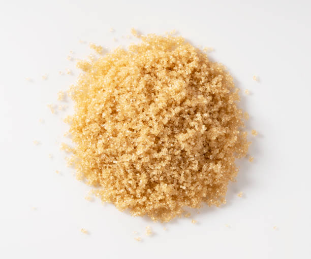 istock Brown sugar placed on a white background. View from directly above. 1353366490