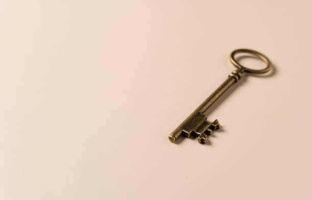 istock Retro brass keys on a beige background with copy space. 1353367073