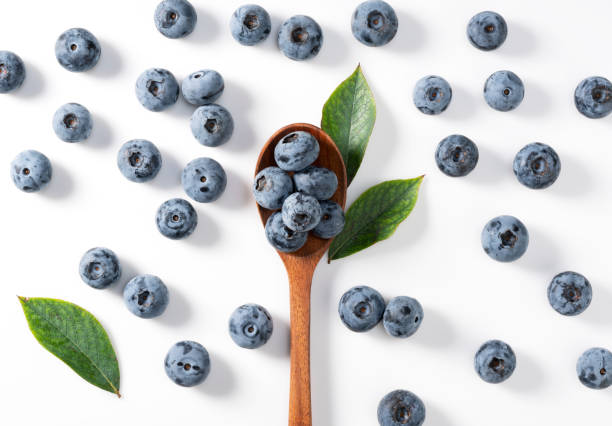istock Blueberries and wooden spoon placed on a white background. 1353367115