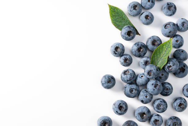 istock Blueberries and blueberry leaves on a white background. 1353367129