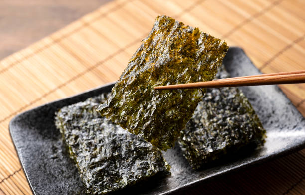 istock Korean seaweed served on a plate on a wooden table. 1353368290