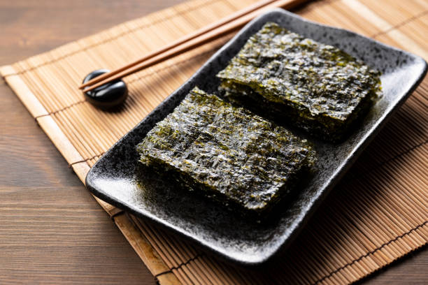 istock Korean seaweed served on a plate on a wooden table. 1353368298