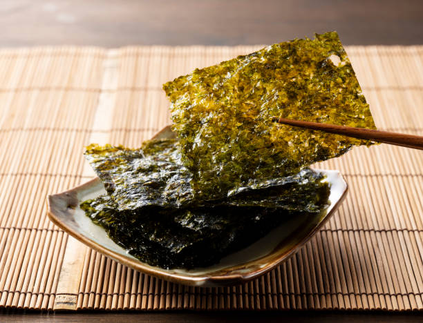 istock Korean seaweed served on a plate on a wooden table. 1353368312