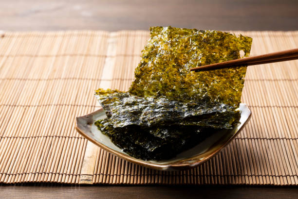 istock Korean seaweed served on a plate on a wooden table. 1353368316
