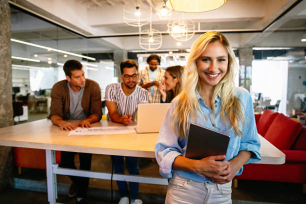 istock Group of happy business people working together on project in office. 1353368406