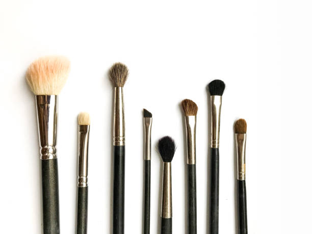 istock makeup brushes in a bunch, makeup artist objects close-up on a white background, soft focus and light blurring 1353368658