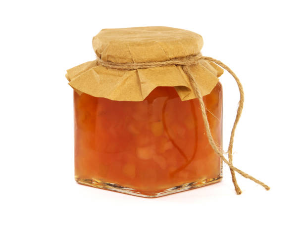 istock Pear and apple jam in a glass jar isolated on white 1353368736