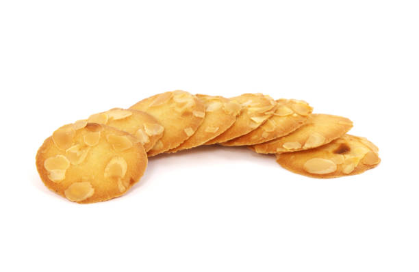 istock Pile of almond flake cookies isolated on white 1353368737