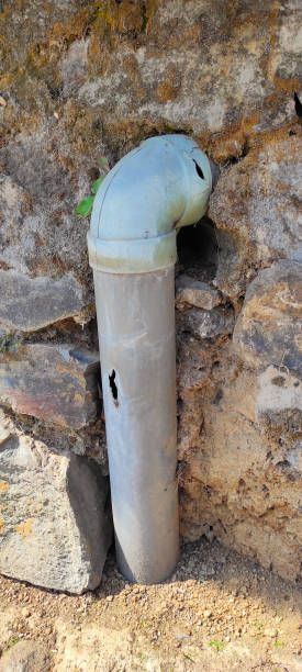 istock cracked and perforated drain pipe - stock photo 1353369042
