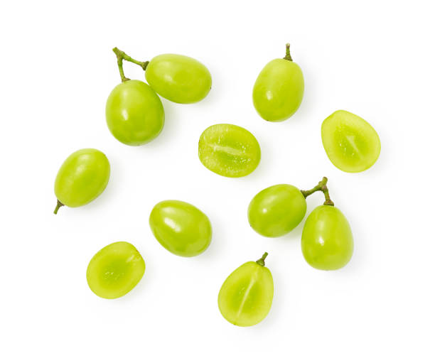 a lot of shine-muscat grapes and cut shine-muscat grapes on a white background. white grapes.  japanese grapes. - shiny group of objects high angle view close up imagens e fotografias de stock