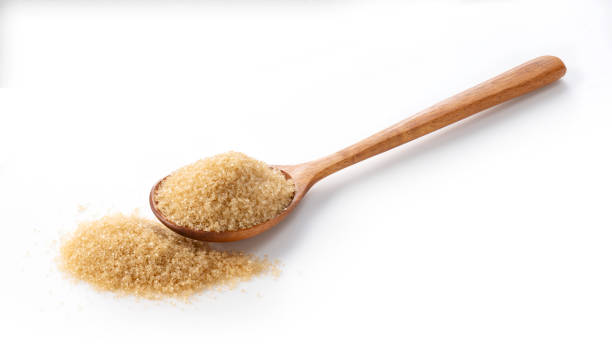 istock Wooden spoon and brown sugar placed on a white background.Focus stacking. 1353370048