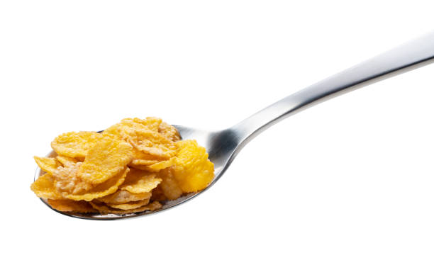 Corn flakes on the spoon isolated on white Corn flakes on the spoon isolated on white corn flakes stock pictures, royalty-free photos & images