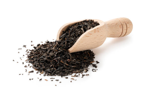 istock Wooden scoop with Earl Grey tea leaves on white background 1353370110
