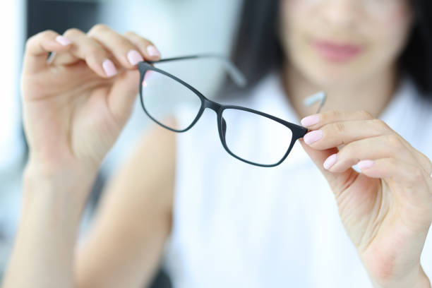 istock Woman holding glasses for vision, close-up 1353370220
