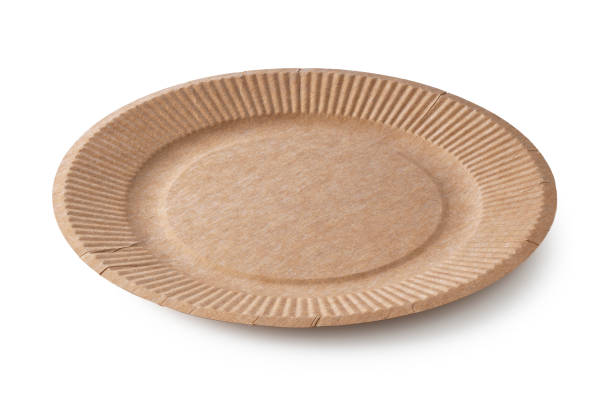 istock Disposable brown paper plates set against a white background. 1353370371