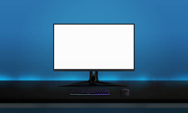 istock Gaming display mockup on black desk with gaming keyboard and mouse. Blue wall with ambient lights in background. Game promotion concept 1353370478
