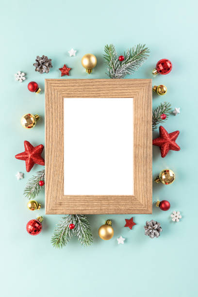 istock Christmas background. Blank xmas photo frame with fir tree branches, holiday decorations on blue background 1353371312
