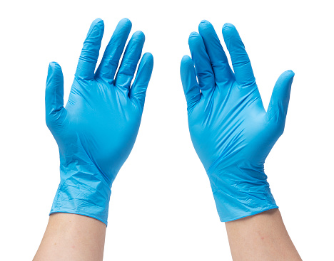 Two hands of a man wearing nitrile gloves on a white background