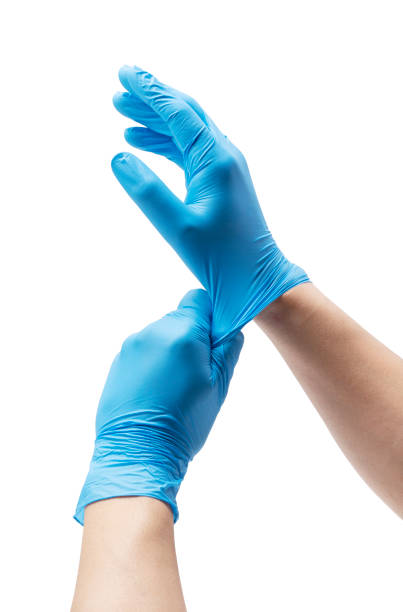 Man's hand wearing nitrile gloves on white background