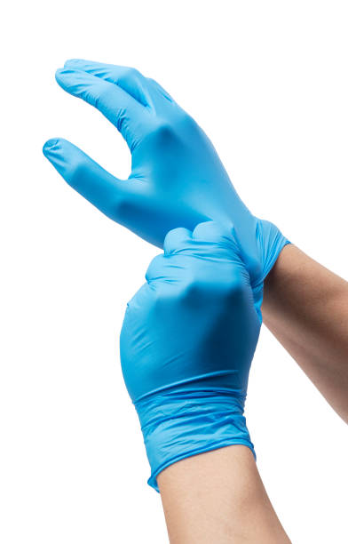 istock Man's hand wearing nitrile gloves on white background 1353371585