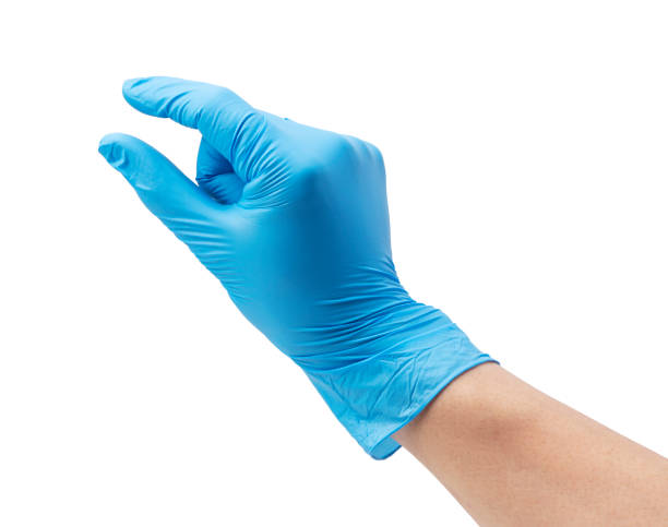 istock Man's hand wearing nitrile gloves on white background 1353371588