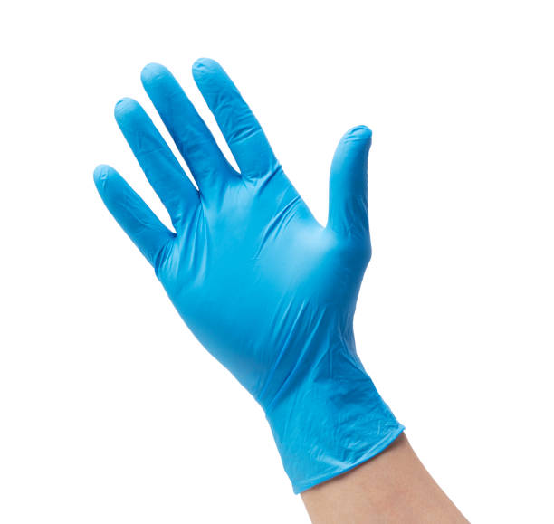 istock Man's hand wearing nitrile gloves on white background 1353371602