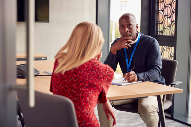 Female University Or College Student Having Individual Meeting With Tutor Or Counsellor Female University Or College Student Having Individual Meeting With Tutor Or Counsellor two people stock pictures, royalty-free photos & images