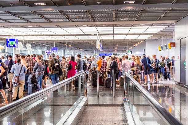 passengers at the departure hall in the airport Frankfurt, Germany - August 16, 2014: passengers at the departure hall. With 38 million passengers per year it is one of the most important airport in Europe. frankfurt international airport stock pictures, royalty-free photos & images