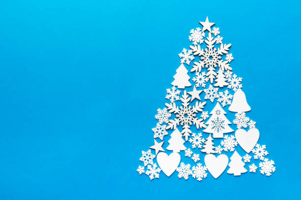 istock Christmas tree made from colored handmade ball decoration on colored background, view from above. New Year minimal concept with copy space 1353373468