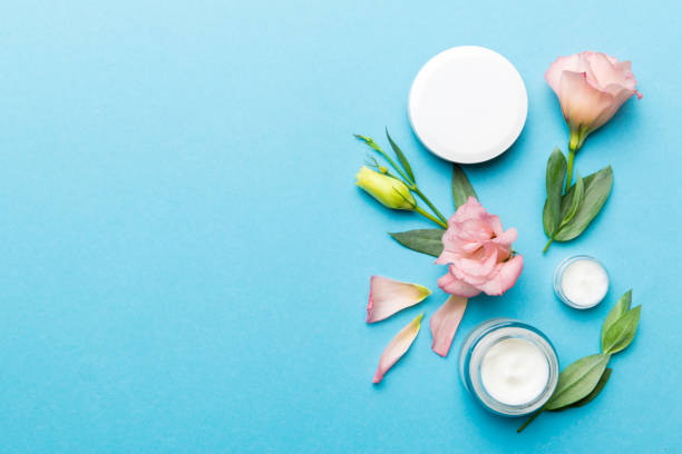 istock Composition with cosmetic products and beautiful roses on color background. Copy space, flat lay 1353373541