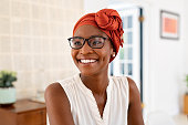 istock Happy smiling black woman with spectacles wearing african turban 1353378823