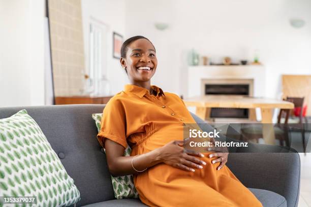 Happy Mature African Pregnant Woman Smiling At Home Stock Photo - Download Image Now