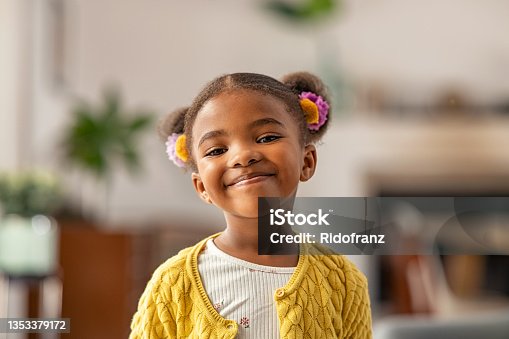istock Cute little african american girl looking at camera 1353379172