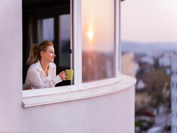 istock Young woman day dreaming during coffee time on a window. 1353379473